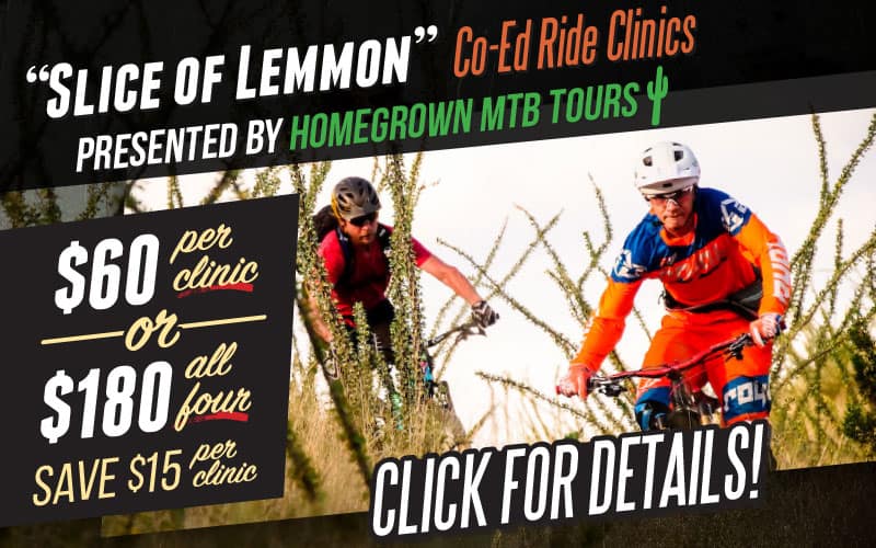 Two cyclists ride mountain bikes on a forest trail during a clinic.